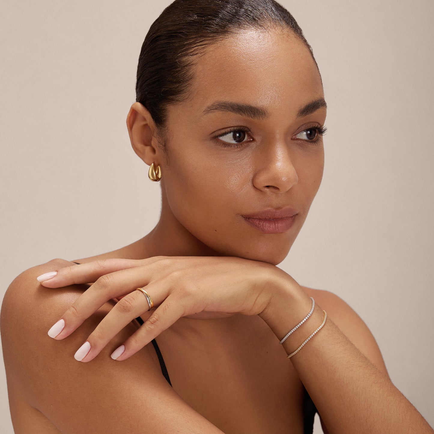 2 tone ring and two tone earring with tennis bracelet on model