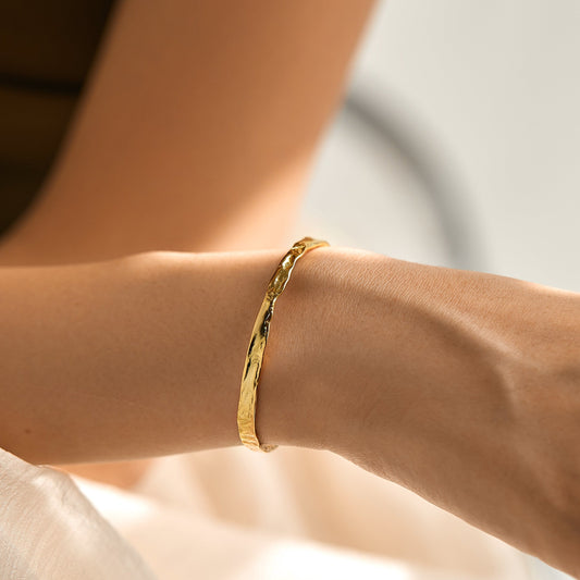 gold bangle cuff on woman